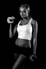 Sexy and fit woman lifting hand weights