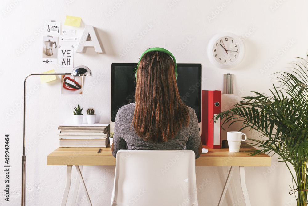 Wall mural young creative woman working at office.