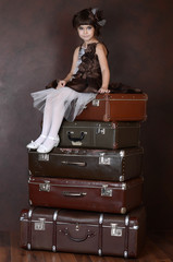 The little girl with old suitcases