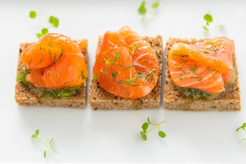 Delicious appetizer canapes of black bread with smoked salmon