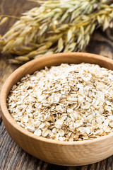 Oat flakes in a wooden bowl