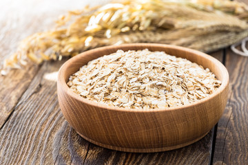 Oat flakes in a wooden bowl