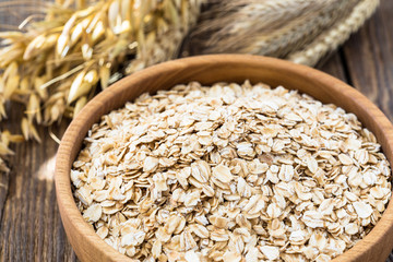 Oat flakes in a wooden bowl