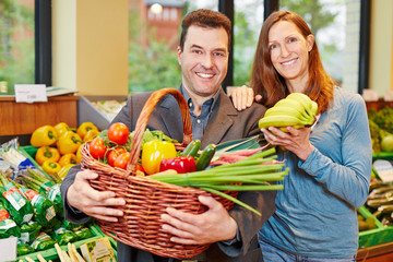 Paar im Bioladen kauft Obst und Gemüse