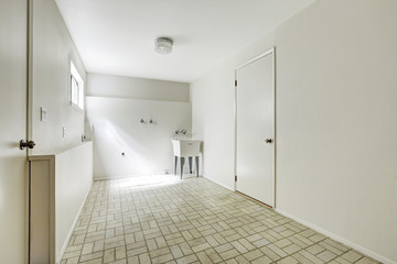 Spacious laundry room in empty house