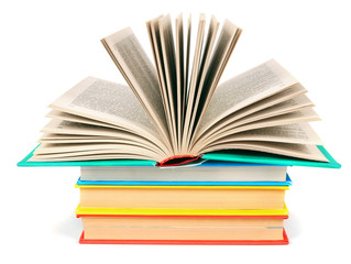 The open book on a pile of multi-coloured books.