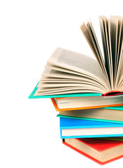 The open book on a pile of multi-coloured books.