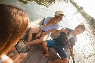 Friends Enjoying On A Boat