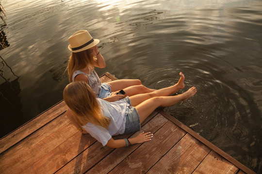Two Girls Relaxing Near River
