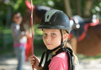 Fototapeta na wymiar Young girl in horseback rider helmet