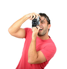 Young man using a retro camera against white background
