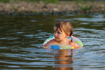 A girl swims in the river