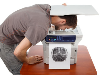 Man scanning his face in copier