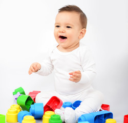 Beautiful baby girl with colorful toys - Studio shot