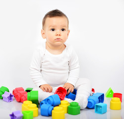 Beautiful baby girl with colorful toys - Studio shot