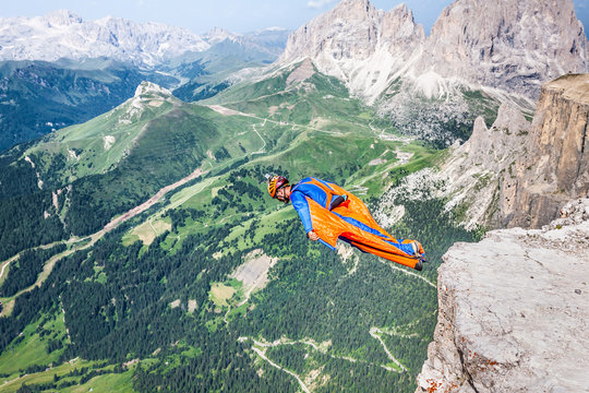 BASE jumper jumping off a big cliff in Dolomites,Italy, breathta