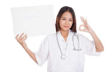 Young Asian female doctor show a blank sign and OK sign