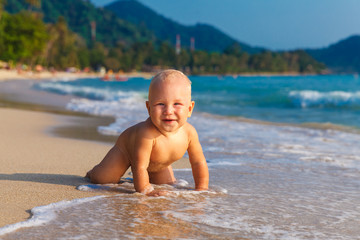 A little kid having fun on a tropical beach.