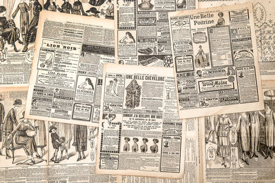 Newspaper pages with antique advertising. Woman's fashion magazi