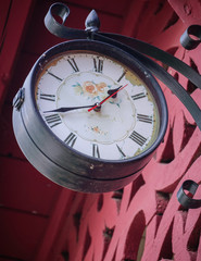 Old railway station clock with red background