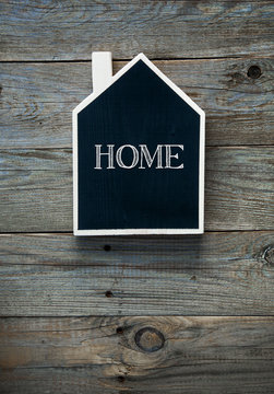 House Shaped Chalkboard sign on rustic wood WELCOME HOME