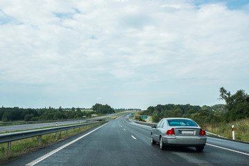 Fototapeta premium Car runs over the road