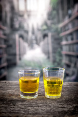 glass shots with yellow liqour resembling whiskey, rum, tequila
