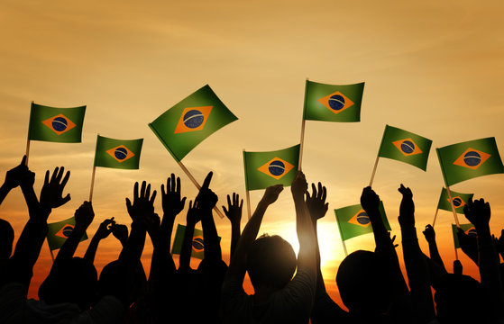 Group of People Waving Brazillian Flags in Back Lit
