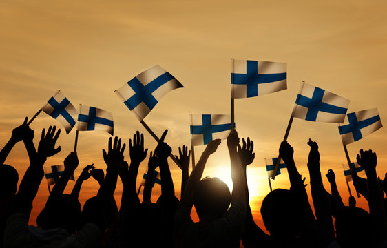 Silhouettes of People Holding the Flag of Finland