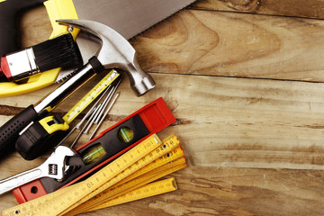 Assorted work tools on wood. Copy space