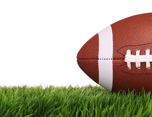American Football. Ball on Green Grass, isolated on white