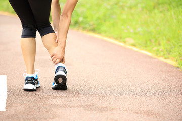 Fototapeta na wymiar woman runner hold her sports twisted ankle