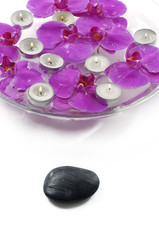 Obraz na płótnie Canvas therapy stones and floral scented water with candle
