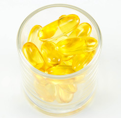 Healthy vitamin glass : yellow oil pills in translucent glass