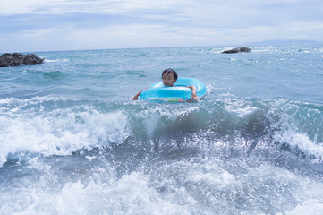 Boy riding a wave in the float