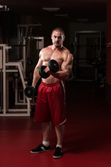 Fototapeta na wymiar Healthy Young Man Doing Exercise For Biceps