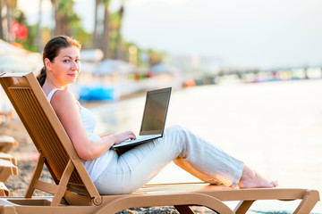 beautiful girl with a laptop in the early morning