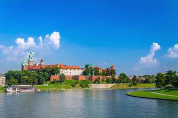 Obraz premium Wawel castle and Vistula river with boats, Cracow, Poland