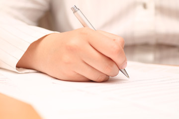 Businesswoman viewing the contract before signing