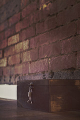 Spooky box on wooden floor with padlock and key