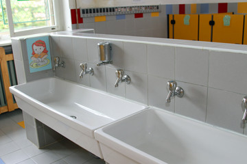 sinks and washbasins with low taps in the toilets of a nursery