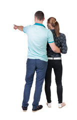 young couple pointing.