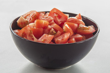Chopped tomato in bowl close up