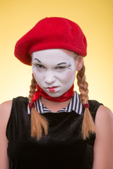 Portrait of female mime isolated on yellow background