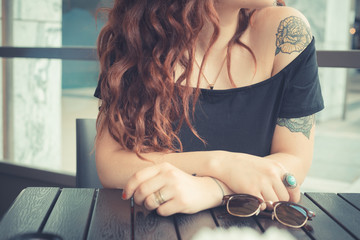 young beautiful hipster woman with red curly hair