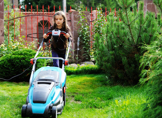 Kid girl with lawn mower