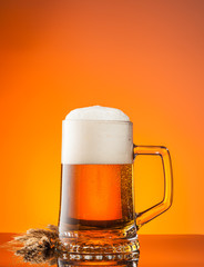 Glass of beer with orange background