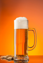 Glass of beer with orange background