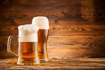 Glasses of beer on wooden planks