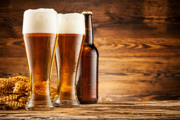 Glasses of beer on wooden planks
